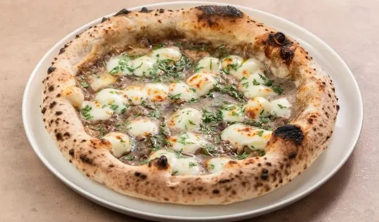 Black truffle pizza with a blistered crust