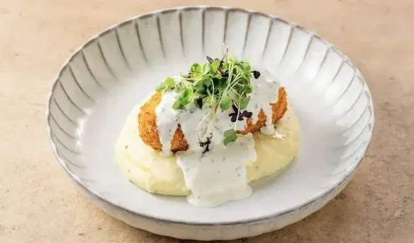 Chicken Kiev on mashed potato with micro herbs